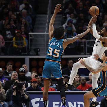 Dec 20, 2022; Detroit, Michigan, USA;  Utah Jazz guard Malik Beasley (5) shoots over Detroit Pistons forward Marvin Bagley III (35) in the first half at Little Caesars Arena. Mandatory Credit: Rick Osentoski-Imagn Images