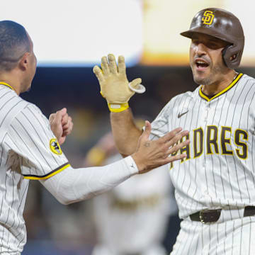 Aug 9, 2025; San Diego, California, USA; San Diego Padres left fielder Ramon Laureano (5) celebrates with third baseman Manny Machado (13) after hitting a walk-off single during the tenth inning against the Boston Red Sox at Petco Park. Mandatory Credit: David Frerker-Imagn Images