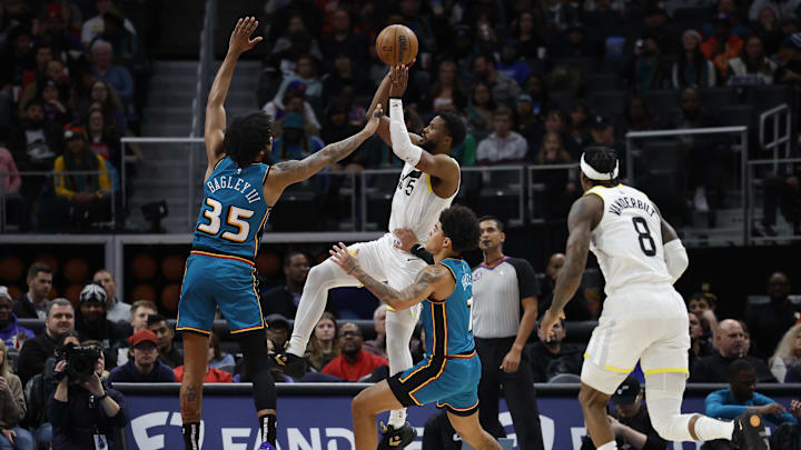 Dec 20, 2022; Detroit, Michigan, USA;  Utah Jazz guard Malik Beasley (5) shoots over Detroit Pistons forward Marvin Bagley III (35) in the first half at Little Caesars Arena. Mandatory Credit: Rick Osentoski-Imagn Images