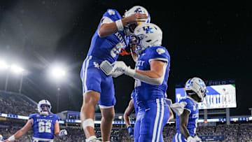 Kentucky Wildcats quarterback Cutter Boley (8), left, celebrates his touchdown pass to Kentucky Wildcats tight end Willie Rodriguez (81) in the second quarter as the Wildcats are rolling in the football game against Eastern Michigan at Kroger Field in Lexington, Kentucky Saturday, Sept. 13, 2025.
