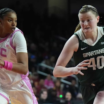 Feb 19, 2025; Los Angeles, California, USA; Michigan State Spartans guard Julia Ayrault (40) dribbles the ball against Southern California Trojans center Rayah Marshall (13) in the second half at the Galen Center. Mandatory Credit: Kirby Lee-Imagn Images