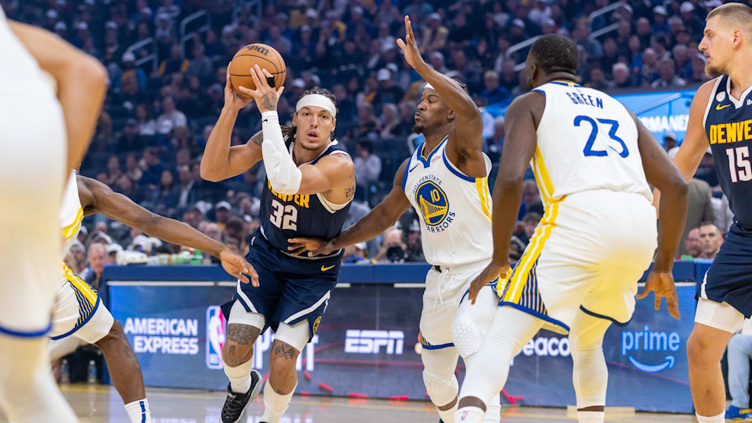 Oct 23, 2025; San Francisco, California, USA;  Denver Nuggets forward Aaron Gordon (32) drives through the defense of Golden State Warriors guard Tim Hardaway Jr. (10) during the first quarter at Chase Center. Mandatory Credit: Bob Kupbens-Imagn Images