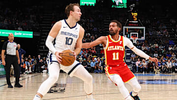 Mar 3, 2025; Memphis, Tennessee, USA; Memphis Grizzlies guard Luke Kennard (10) handles the ball as Atlanta Hawks guard Trae Young (11) defends during the third quarter at FedExForum. Mandatory Credit: Petre Thomas-Imagn Images