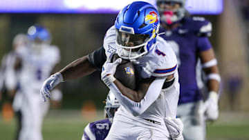 Oct 26, 2024; Manhattan, Kansas, USA; Kansas Jayhawks running back Devin Neal (4) is tackled by Kansas State Wildcats safety Jordan Riley (6) during the third quarter at Bill Snyder Family Football Stadium. Mandatory Credit: Scott Sewell-Imagn Images