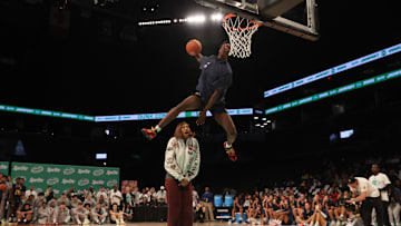 Mar 31, 2025; Brooklyn, New York, USA; McDonald’s All American West forward AJ Dybantsa (3) dunks the ball over  Chicago Sky forward Angel Reese during the Sprite Jam Fest