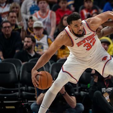 Mar 15, 2025; San Francisco, California, USA; New York Knicks center Karl-Anthony Towns (32) controls the basketball against Golden State Warriors forward Draymond Green (23) during the third quarter at Chase Center. Mandatory Credit: Neville E. Guard-Imagn Images