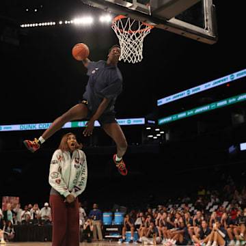 Mar 31, 2025; Brooklyn, New York, USA; McDonald’s All American West forward AJ Dybantsa (3) dunks the ball over  Chicago Sky forward Angel Reese during the Sprite Jam Fest