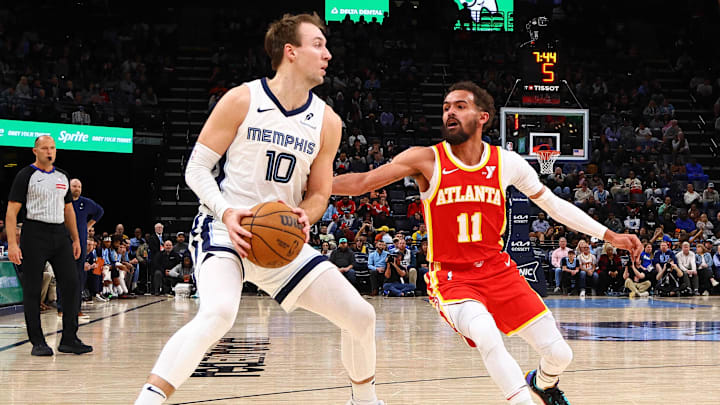 Mar 3, 2025; Memphis, Tennessee, USA; Memphis Grizzlies guard Luke Kennard (10) handles the ball as Atlanta Hawks guard Trae Young (11) defends during the third quarter at FedExForum. Mandatory Credit: Petre Thomas-Imagn Images