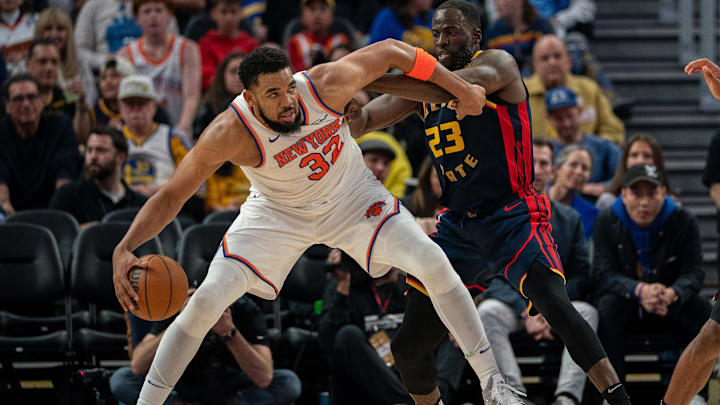 Mar 15, 2025; San Francisco, California, USA; New York Knicks center Karl-Anthony Towns (32) controls the basketball against Golden State Warriors forward Draymond Green (23) during the third quarter at Chase Center. Mandatory Credit: Neville E. Guard-Imagn Images
