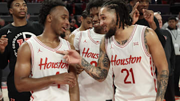 Jan 15, 2025; Houston, Texas, USA; From left to right Houston Cougars guard L.J. Cryer (4) guard Kordelius Jefferson (0) and  guard Emanuel Sharp (21) celebrate after defeating the West Virginia Mountaineers in the second half at Fertitta Center. Mandatory Credit: Thomas Shea-Imagn Images