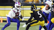 Nov 30, 2025; Pittsburgh, Pennsylvania, USA; Buffalo Bills running back James Cook III (4) rushes as Pittsburgh Steelers cornerback Jalen Ramsey (5) defends during the fourth quarter at Acrisure Stadium. Mandatory Credit: Charles LeClaire-Imagn Images