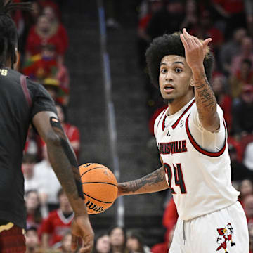 Feb 22, 2025; Louisville, Kentucky, USA;  Louisville Cardinals guard Chucky Hepburn (24) calls a play while dribbling against Florida State Seminoles guard Jamir Watkins (1) during the second half at KFC Yum! Center. Louisville defeated Florida State 89-81. Mandatory Credit: Jamie Rhodes-Imagn Images