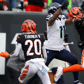 Cincinnati Bengals CB Mike Hilton intercepts the pass in front of Seattle Seahawks wide receiver Jaxon Smith-Njigba.