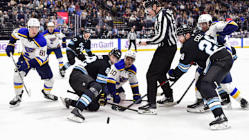 Jan 18, 2025; Salt Lake City, Utah, USA; Utah Hockey Club center Kevin Stenlund (82) and St. Louis Blues center Brayden Schenn (10) face-off during third period at the Delta Center. Mandatory Credit: Christopher Creveling-Imagn Images
