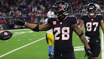 Houston Texans running back Joe Mixon (28) reacts to his rushing first down against the Los Angeles Chargers in the fourth quarter in an AFC wild card game at NRG Stadium.