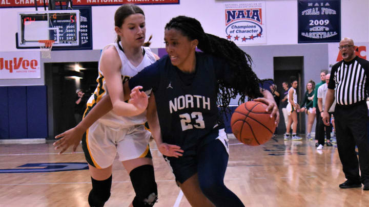 Rock Bridge's Mari Miller (31) defends Blue Valley North's Aubrey Shaw (23) during a basketball on December 2, 2022