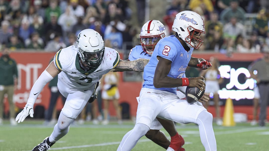Nov 23, 2024; Houston, Texas, USA; Houston Cougars quarterback Zeon Chriss (2) runs with the ball as Baylor Bears linebacker Matt Jones (2) attempts to make a tackle during the third quarter at TDECU Stadium. Mandatory Credit: Troy Taormina-Imagn Images Nov 23, 2024; Houston, Texas, USA; Houston Cougars quarterback Zeon Chriss (2) runs with the ball as Baylor Bears linebacker Matt Jones (2) attempts to make a tackle during the third quarter at TDECU Stadium. Mandatory Credit: Troy Taormina-Imagn Images