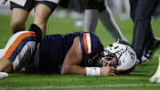 Nov 8, 2025; Charlottesville, Virginia, USA; Virginia Cavaliers quarterback Chandler Morris (4) lays on the field after being injected against the Wake Forest Demon Deacons during the first half at Scott Stadium. Mandatory Credit: Amber Searls-Imagn Images