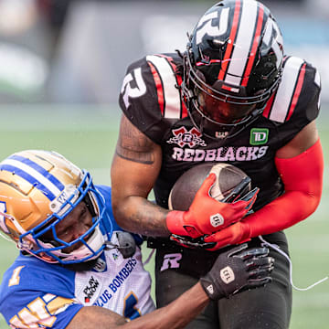 Jun 13, 2024; Ottawa, Ontario, CAN; Defensive back Deatrick Nichols (1) of the Winnipeg Blue Bombers tackles wide receiver Bralon Addison (1) of the Ottawa REDBLACKS in the first half at TD Place. Mandatory Credit: Marc DesRosiers-Imagn Images