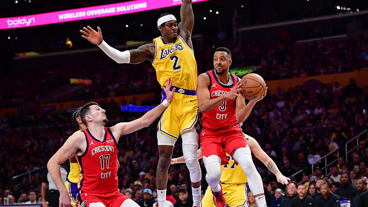 Mar 4, 2025; Los Angeles, California, USA; New Orleans Pelicans guard CJ McCollum (3) passes the ball against Los Angeles Lakers forward Jarred Vanderbilt (2) during the second half at Crypto.com Arena. Mandatory Credit: Gary A. Vasquez-Imagn Images