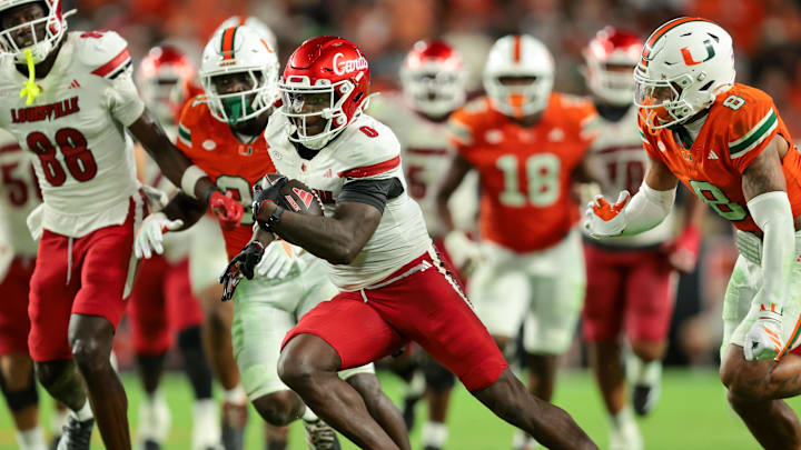 Oct 17, 2025; Miami Gardens, Florida, USA; Louisville Cardinals wide receiver Chris Bell (0) carries the football for a touchdown against the Miami Hurricanes during the fourth quarter at Hard Rock Stadium. Mandatory Credit: Sam Navarro-Imagn Images