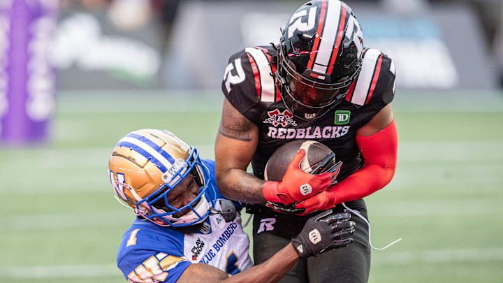 Jun 13, 2024; Ottawa, Ontario, CAN; Defensive back Deatrick Nichols (1) of the Winnipeg Blue Bombers tackles wide receiver Bralon Addison (1) of the Ottawa REDBLACKS in the first half at TD Place. Mandatory Credit: Marc DesRosiers-Imagn Images