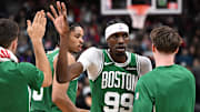 Oct 10, 2025; Toronto, Ontario, CAN: Boston Celtics forward Chris Boucher (99) slaps hands with team mates after making a basket against the Toronto Raptors in the first half at Scotiabank Arena. Mandatory Credit: Dan Hamilton-Imagn Images