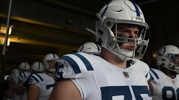 Colts guard Will Fries (white uniform) looks on before a game starts. 