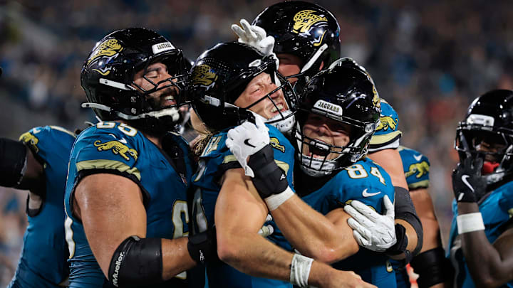 Jacksonville Jaguars quarterback Trevor Lawrence (16) is celebrated by offensive tackle Patrick Mekari (65) and tight end Hunter Long (84) for his touchdown score with other teammates joining in for his game-winning touchdown during the fourth quarter of an NFL football matchup at EverBank Stadium, Monday, Oct. 6, 2025, in Jacksonville, Fla. 