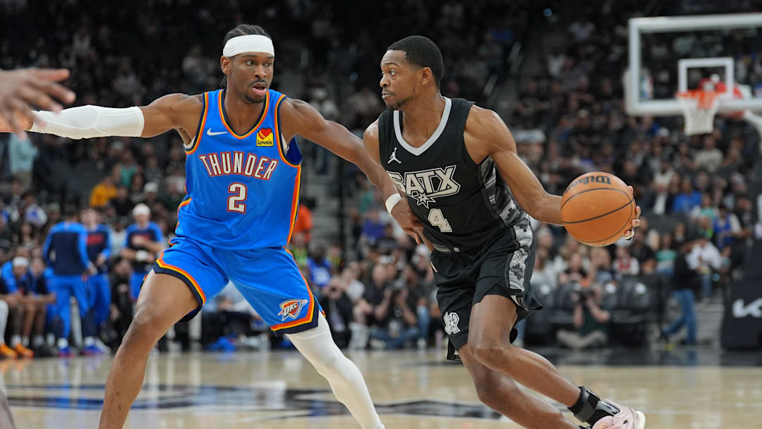 Mar 2, 2025; San Antonio, Texas, USA; San Antonio Spurs guard De'Aaron Fox (4) dribbles against Oklahoma City Thunder guard Shai Gilgeous-Alexander (2) in the first half at Frost Bank Center. Mandatory Credit: Daniel Dunn-Imagn Images Mar 2, 2025; San Antonio, Texas, USA; San Antonio Spurs guard De'Aaron Fox (4) dribbles against Oklahoma City Thunder guard Shai Gilgeous-Alexander (2) in the first half at Frost Bank Center. Mandatory Credit: Daniel Dunn-Imagn Images