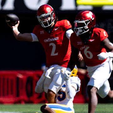 Cincinnati Bearcats quarterback Brendan Sorsby (2) throws a pass as Pittsburgh Panthers defensive back Rashad Battle (15) tackles him in the first quarter of the College Football game between the Cincinnati Bearcats and the Pittsburgh Panthers at Nippert Stadium in Cincinnati on Saturday, Sept. 7, 2024.