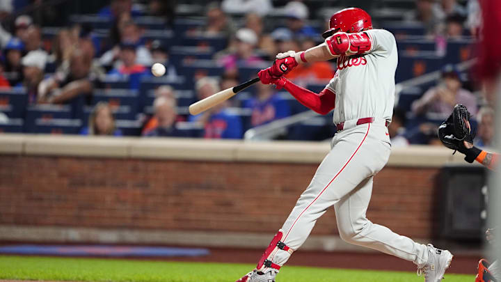 Sep 22, 2024; New York City, New York, USA; Philadelphia Phillies third baseman Alec Bohm (28) hits an RBI single against the New York Mets during the first inning at Citi Field.
