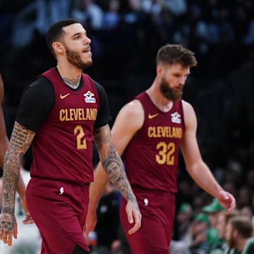 Oct 29, 2025; Boston, Massachusetts, USA; Cleveland Cavaliers guard Lonzo Ball (2), center Evan Mobley (4), forward/center Dean Wade (32) and forward/guard De'Andre Hunter (12) head back to the bench during a timeout against the Boston Celtics in the second half at TD Garden. Mandatory Credit: David Butler II-Imagn Images