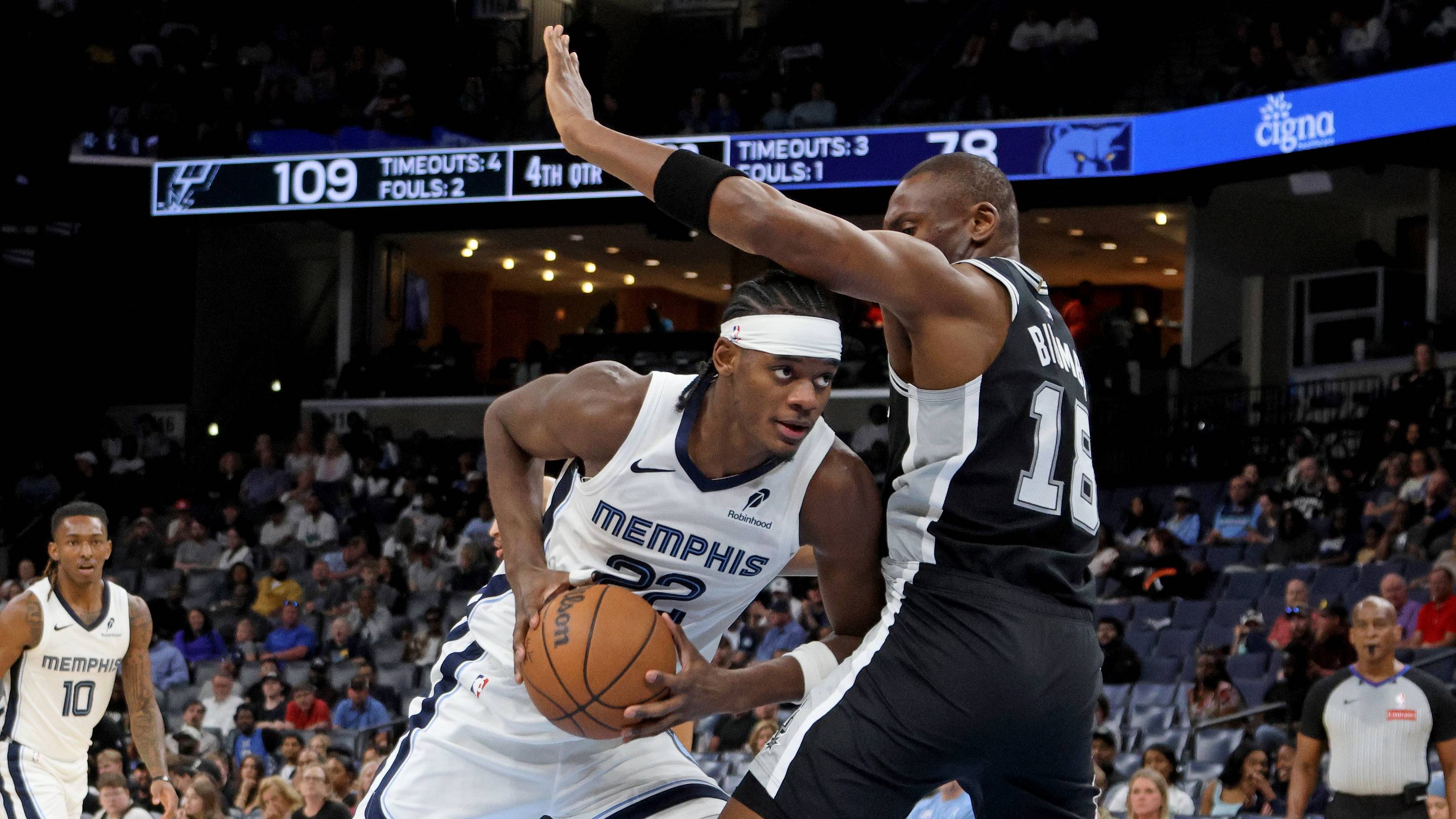 Mar 25, 2026; Memphis, Tennessee, USA; Memphis Grizzlies forward Taylor Hendricks (22) drives to the basket as San Antonio Spurs center Bismack Biyombo (18) defends during the fourth quarter at FedExForum. Mandatory Credit: Petre Thomas-Imagn Images