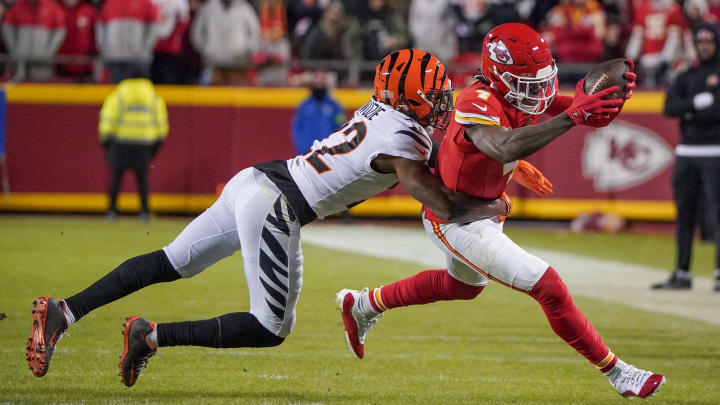 Dec 31, 2023; Kansas City, Missouri, USA; Kansas City Chiefs wide receiver Rashee Rice (4) catches a pass as Cincinnati Bengals cornerback Chidobe Awuzie (22) makes the tackle during the second half at GEHA Field at Arrowhead Stadium. Mandatory Credit: Denny Medley-USA TODAY Sports