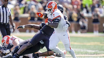 Oct 12, 2024; Winston-Salem, North Carolina, USA; Clemson Tigers running back Phil Mafah (7) tries to elude a tackle by a Wake Forest Demon Deacons defender during the first half at Allegacy Federal Credit Union Stadium. Mandatory Credit: Jim Dedmon-Imagn Images