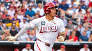 Jun 14, 2025; Omaha, Neb, USA; Arkansas Razorbacks shortstop Wehiwa Aloy (9) runs after hitting a single against the LSU Tigers during the fourth inning at Charles Schwab Field. Mandatory Credit: Dylan Widger-Imagn Images