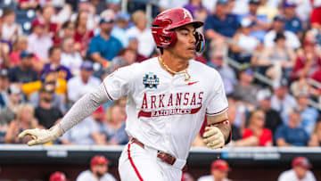 Jun 14, 2025; Omaha, Neb, USA; Arkansas Razorbacks shortstop Wehiwa Aloy (9) runs after hitting a single against the LSU Tigers during the fourth inning at Charles Schwab Field. Mandatory Credit: Dylan Widger-Imagn Images