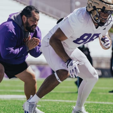 Jordan PaoPao instructs tight end Quentin Moore during spring ball. 