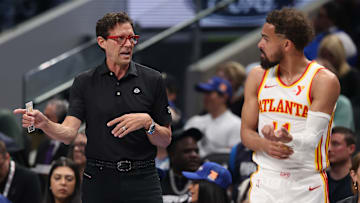 Atlanta Hawks head coach Quin Snyder talks with Trae Young #11 against the Dallas Mavericks.
