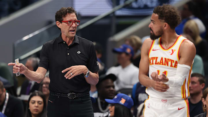 Atlanta Hawks head coach Quin Snyder talks with Trae Young #11 against the Dallas Mavericks.