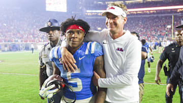 Nov 15, 2025; Oxford, Mississippi, USA; Mississippi Rebels head coach Lane Kiffin embraces running back Kewan Lacy (5) after defeating the Florida Gators at Vaught-Hemingway Stadium. Mandatory Credit: Petre Thomas-Imagn Images