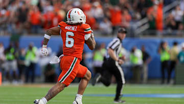 Dec 28, 2024; Orlando, FL, USA; Miami Hurricanes running back Damien Martinez (6) runs for a touchdown against the Iowa State Cyclones in the first quarter during the Pop Tarts bowl at Camping World Stadium. Mandatory Credit: Nathan Ray Seebeck-Imagn Images