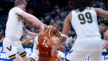 Texas Longhorns guard Tramon Mark (12) muscles his way past Vanderbilt Commodores guard Tyler Nickel (5) during their first round game of the SEC Men's Basketball Tournament at Bridgestone Arena in Nashville, Tenn., Wednesday, March 12, 2025.