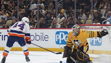 Oct 9, 2025; Pittsburgh, Pennsylvania, USA;  Pittsburgh Penguins goaltender Tristan Jarry (35) makes a save against New York Islanders center Jean-Gabriel Pageau (44) during the second period at PPG Paints Arena. Mandatory Credit: Charles LeClaire-Imagn Images