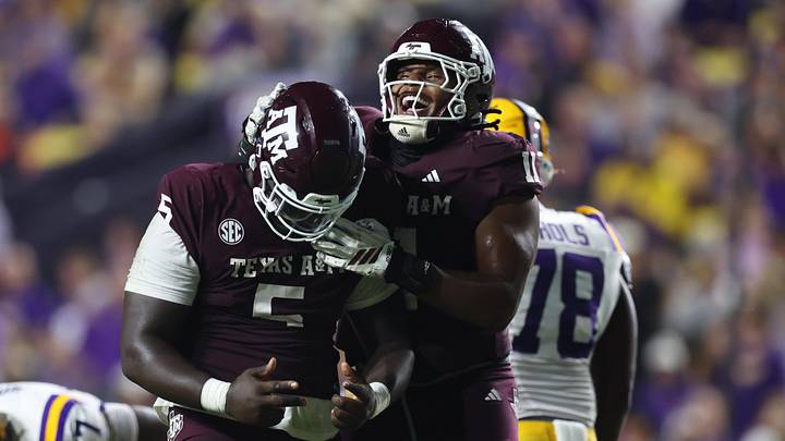 Oct 25, 2025; Baton Rouge, Louisiana, USA; Texas A&M Aggies defensive tackle DJ Hicks (5) celebrates with defensive tackle Tyler Onyedim (11) after a play during the second half against the Louisiana State Tigers at Tiger Stadium. Mandatory Credit: Stephen Lew-Imagn Images