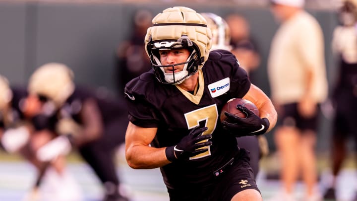 New Orleans Saints quarterback Taysom Hill rushes with the ball during practice at Yulman Stadium.