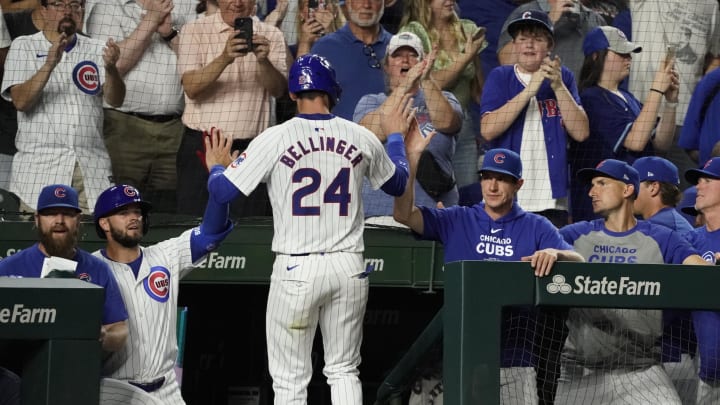 Jun 18, 2024; Chicago, Illinois, USA; Chicago Cubs outfielder Cody Bellinger (24) is greeted after scoring against the San Francisco Giants during the eighth inning at Wrigley Field. Mandatory Credit: David Banks-USA TODAY Sports