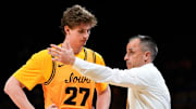 Iowa head coach Ben McCollum talks to Iowa center Trevin Jirak (27) during a game against the Maryland Terrapins Dec. 6, 2025 at Carver-Hawkeye Arena in Iowa City, Iowa.