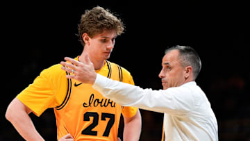 Iowa head coach Ben McCollum talks to Iowa center Trevin Jirak (27) during a game against the Maryland Terrapins Dec. 6, 2025 at Carver-Hawkeye Arena in Iowa City, Iowa.